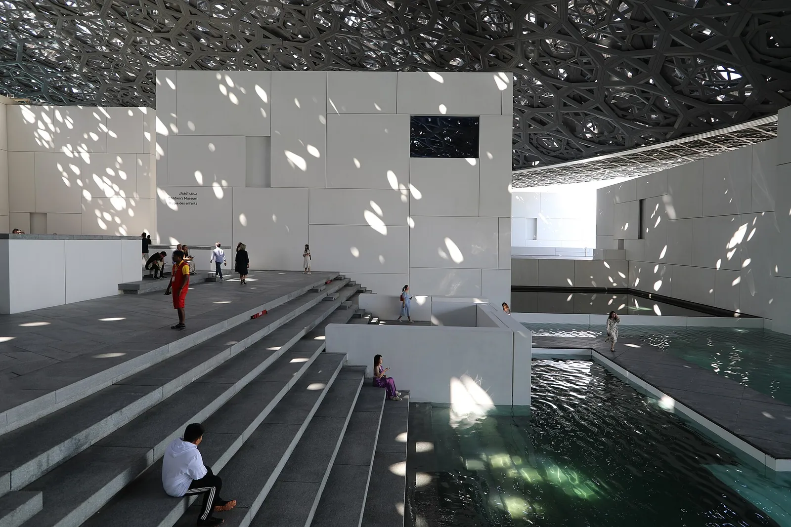Sunlight dappling the plaza under the Louvre Abu Dhabi dome