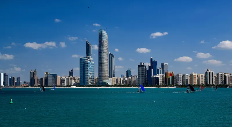 Abu Dhabi skyline rising over bright turquoise water