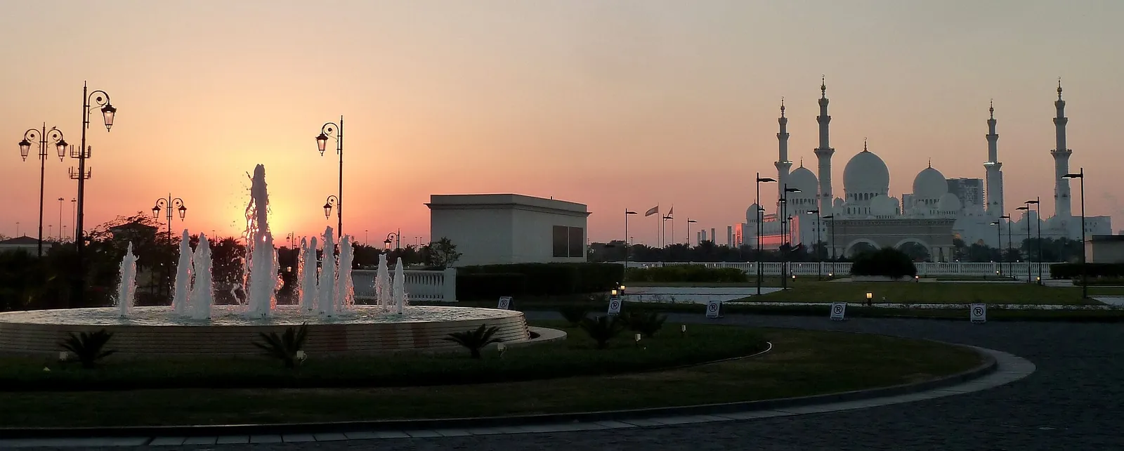 Sheikh Zayed Grand Mosque silhouetted at sunset