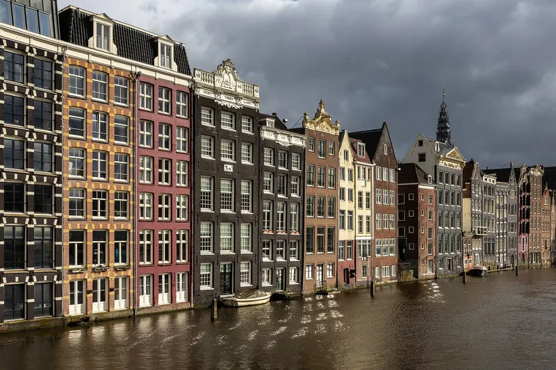 Colourful canal houses on the Damrak at golden hour