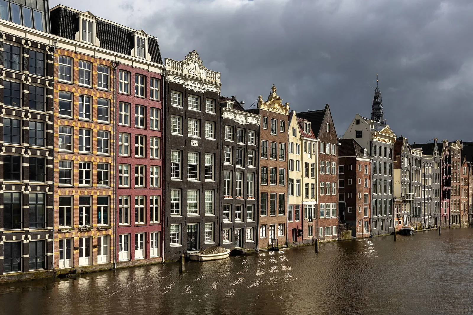 Colourful canal houses on the Damrak at golden hour