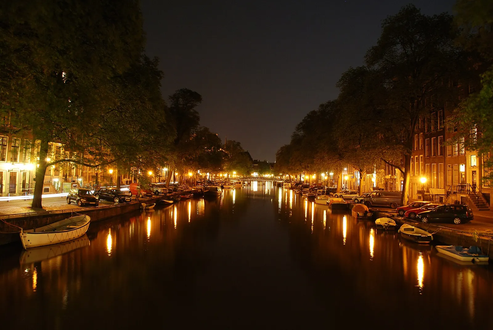 Lights reflected in a canal on a calm evening