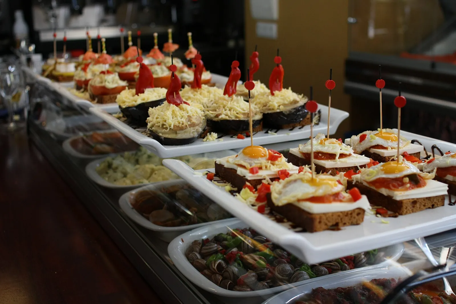 A bar counter lined with colourful tapas