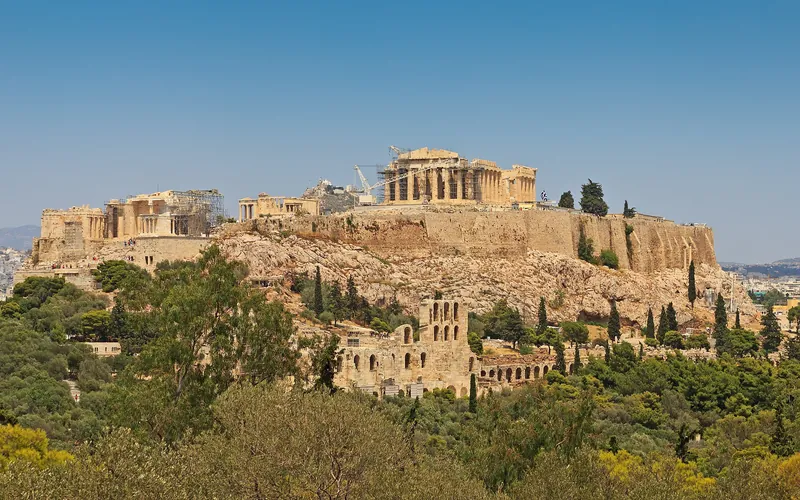 The Acropolis rising above green hills in Athens
