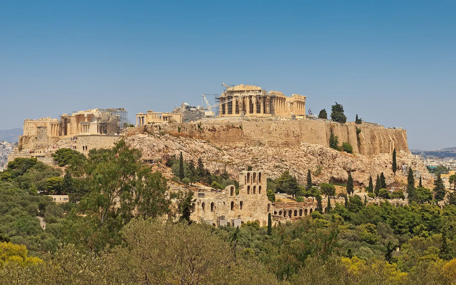The Acropolis rising above green hills in Athens