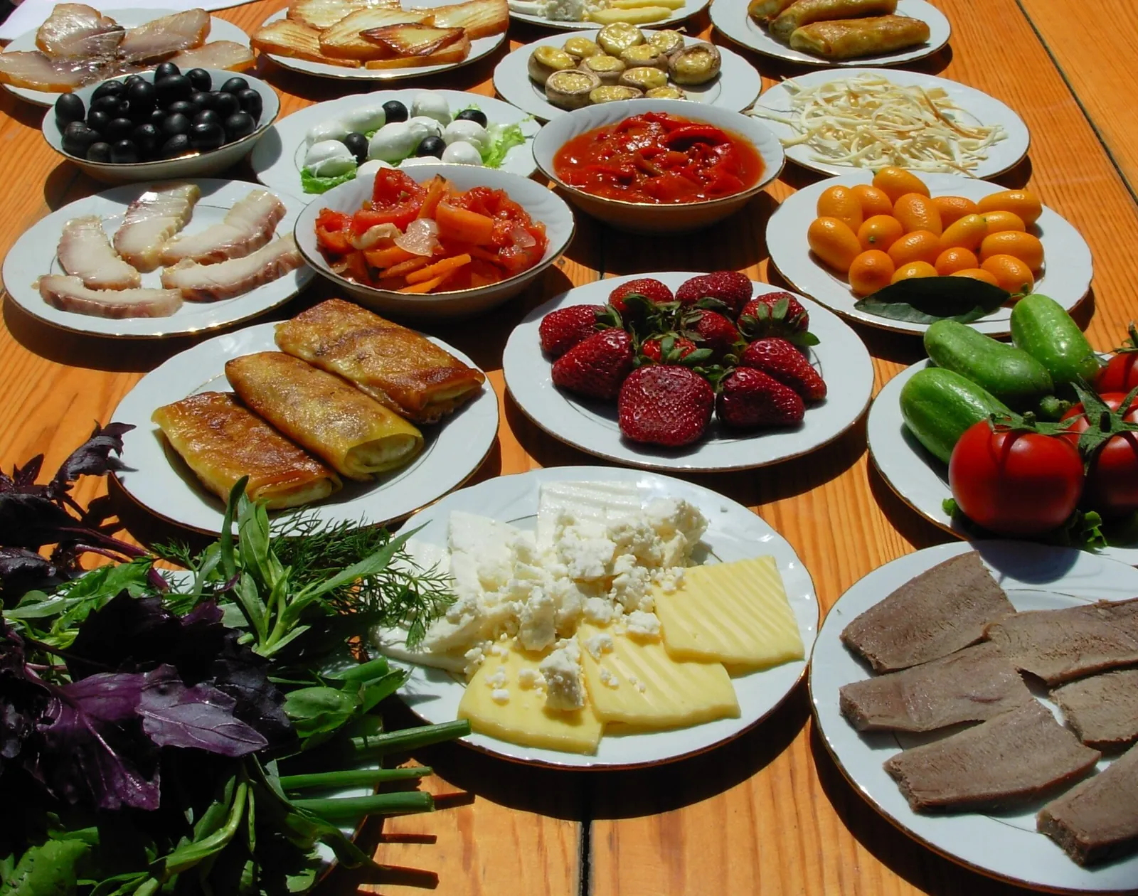 A colourful spread of Azerbaijani snacks, cheese and greens