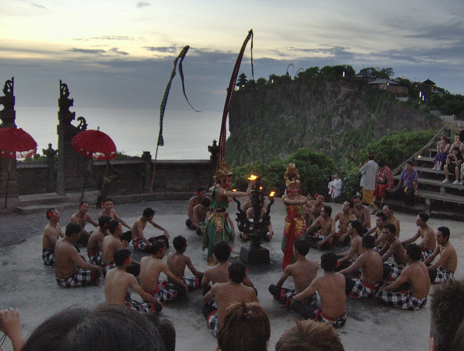 Kecak dancers performing at the clifftop stage in Uluwatu