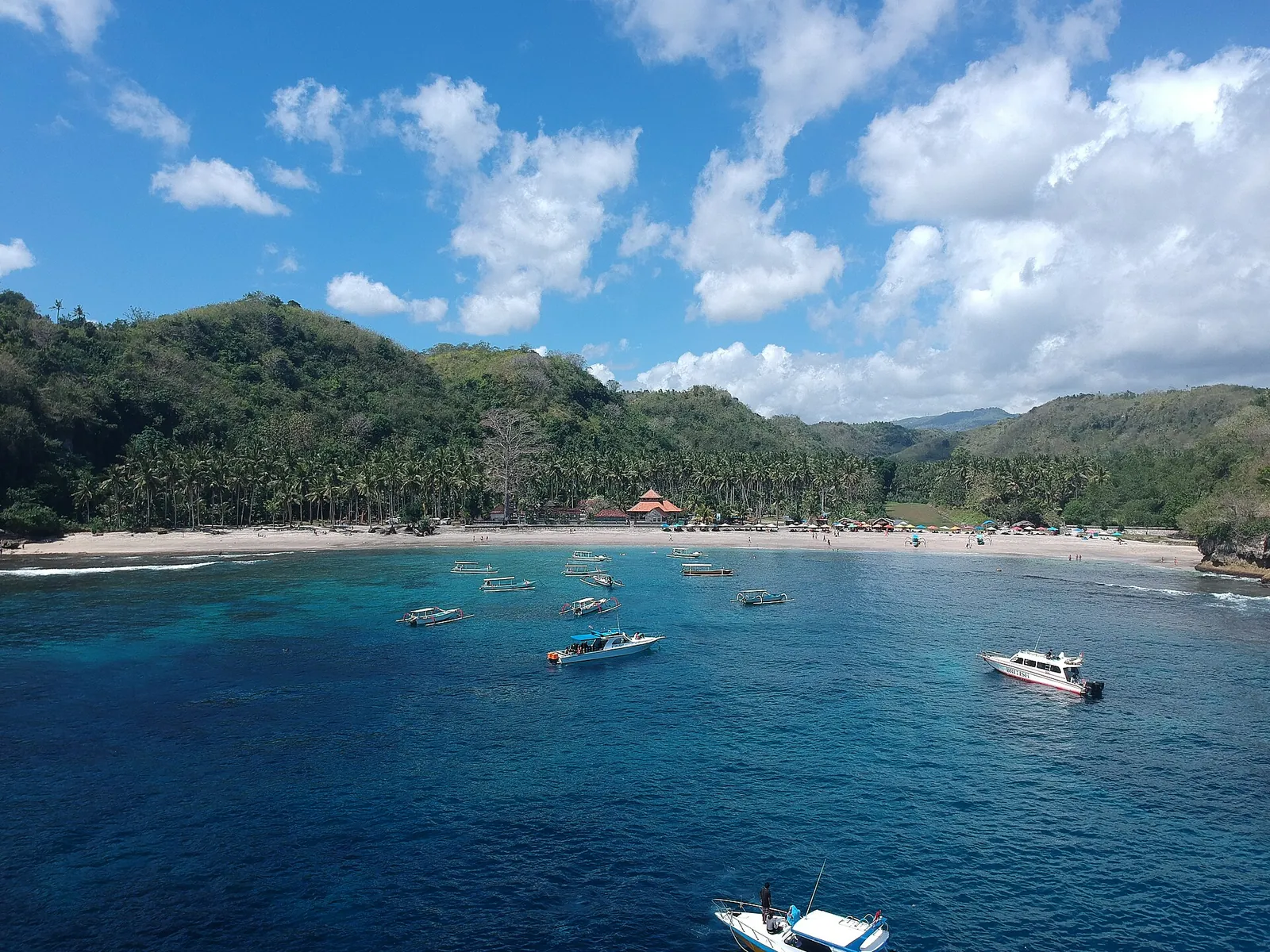 Boats anchored in a turquoise bay on Nusa Penida