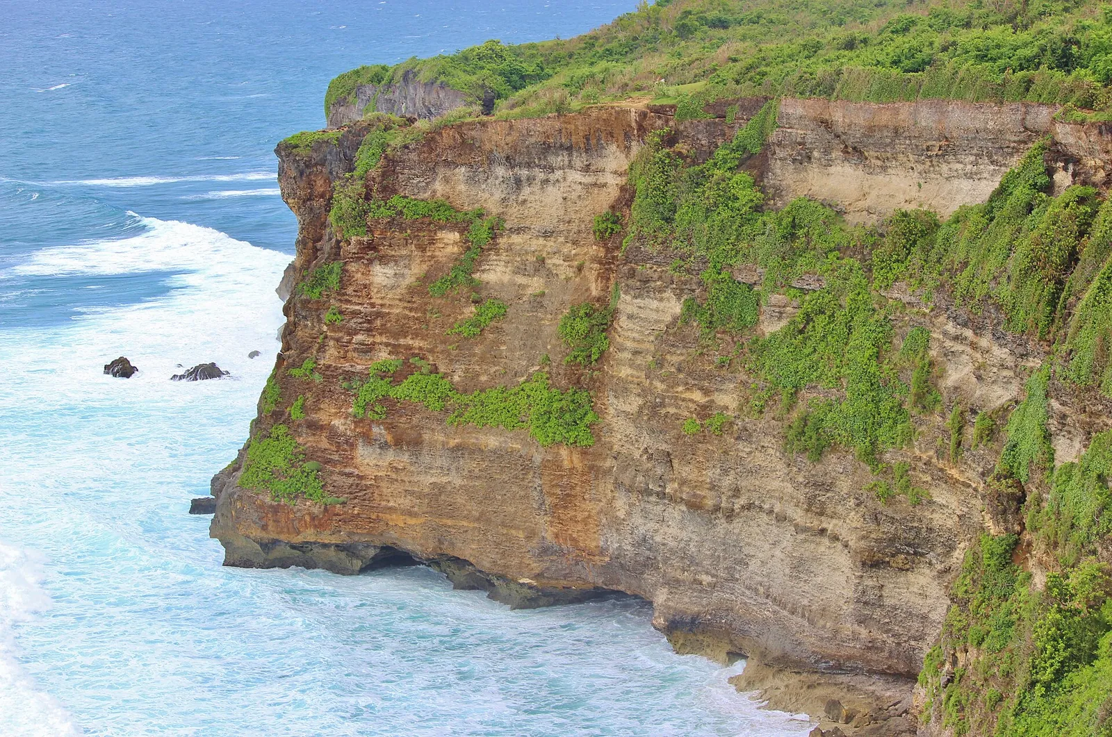 Green-topped limestone cliffs at Uluwatu above turquoise sea