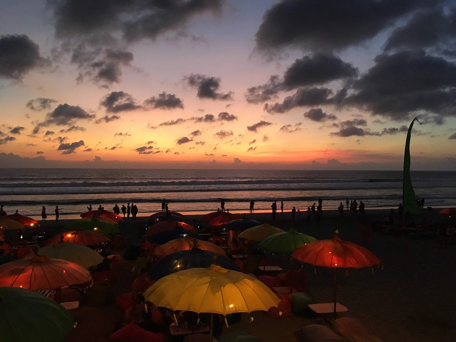Colourful beach umbrellas at sunset on Seminyak Beach
