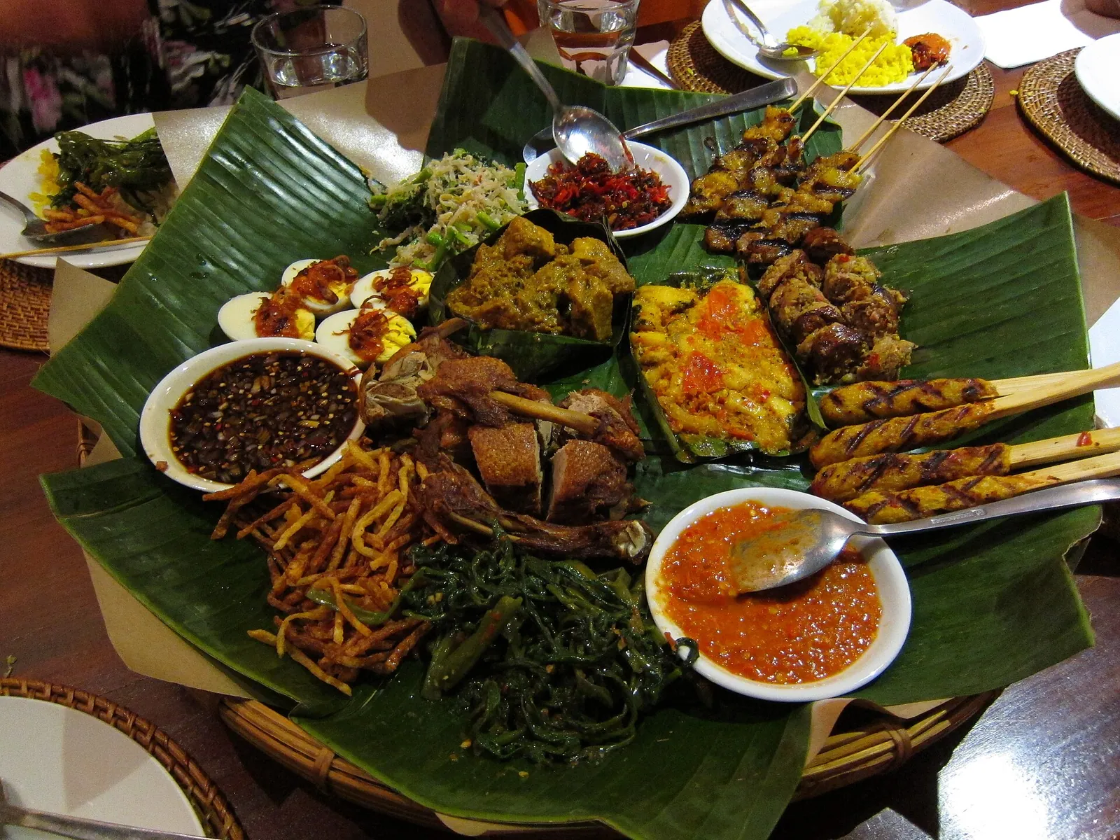 A spread of Balinese dishes on banana leaves