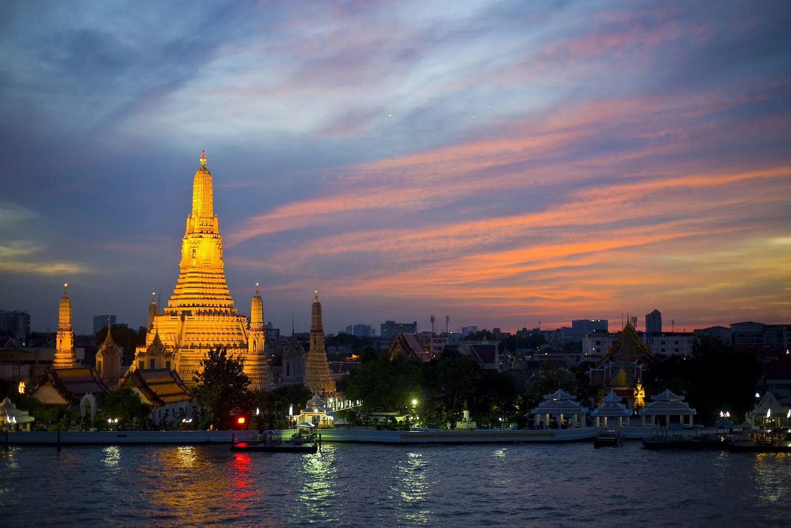 Wat Arun glowing over the Chao Phraya at sunset