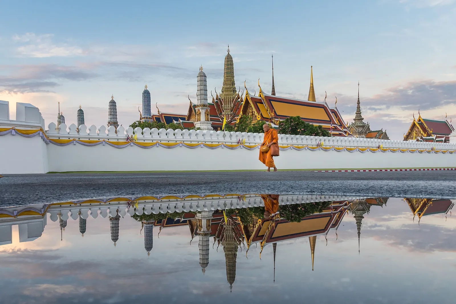 Wat Phra Kaew's golden spires reflected after rain