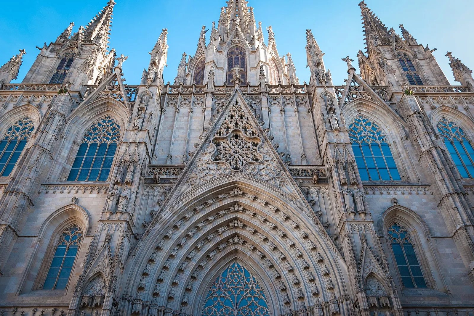 Gothic façade of Barcelona Cathedral under a blue sky