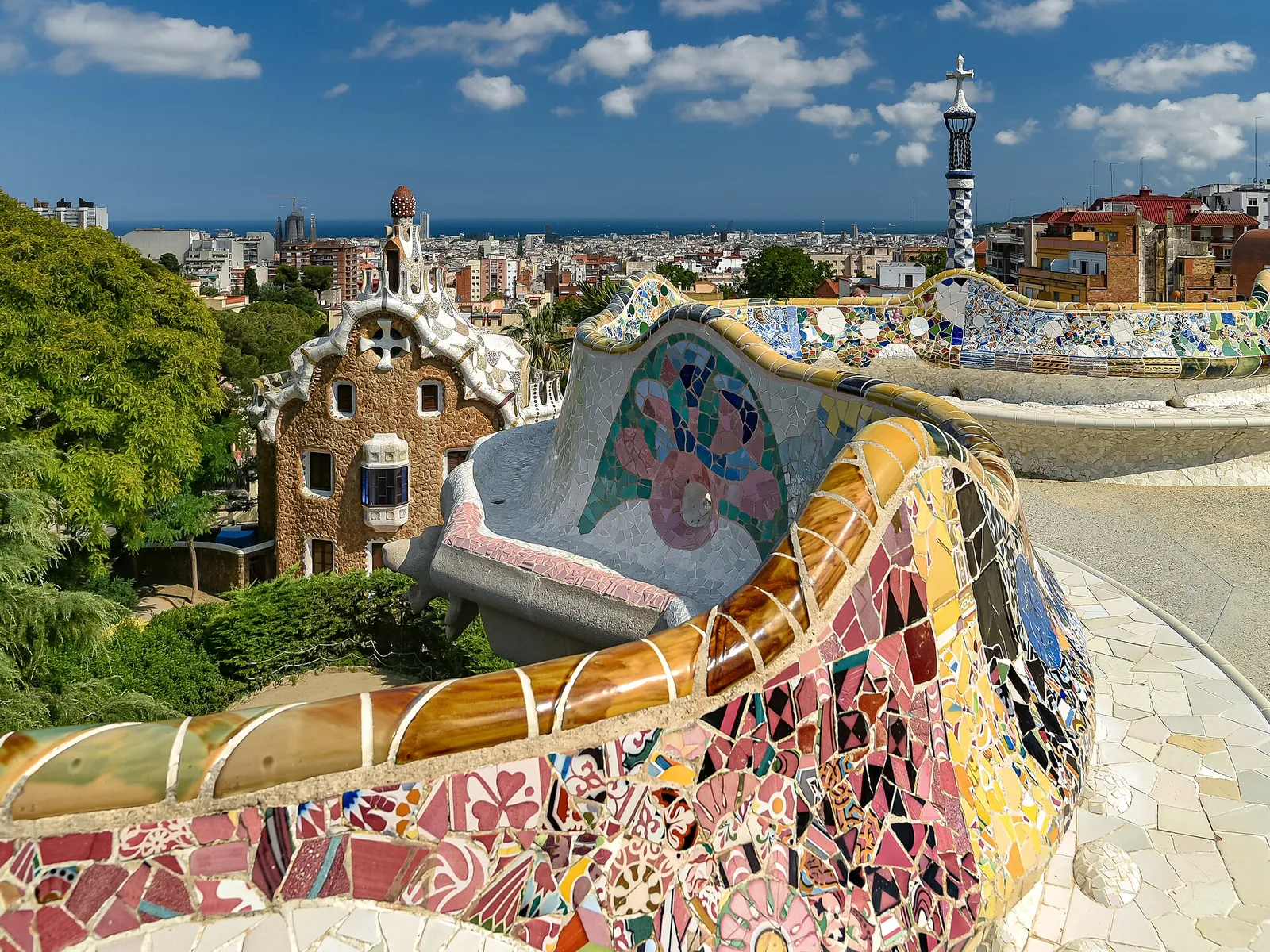 Mosaic bench and gatehouse views at Park Güell