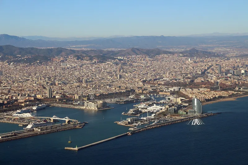 Aerial view of Barcelona's port, beaches and city grid