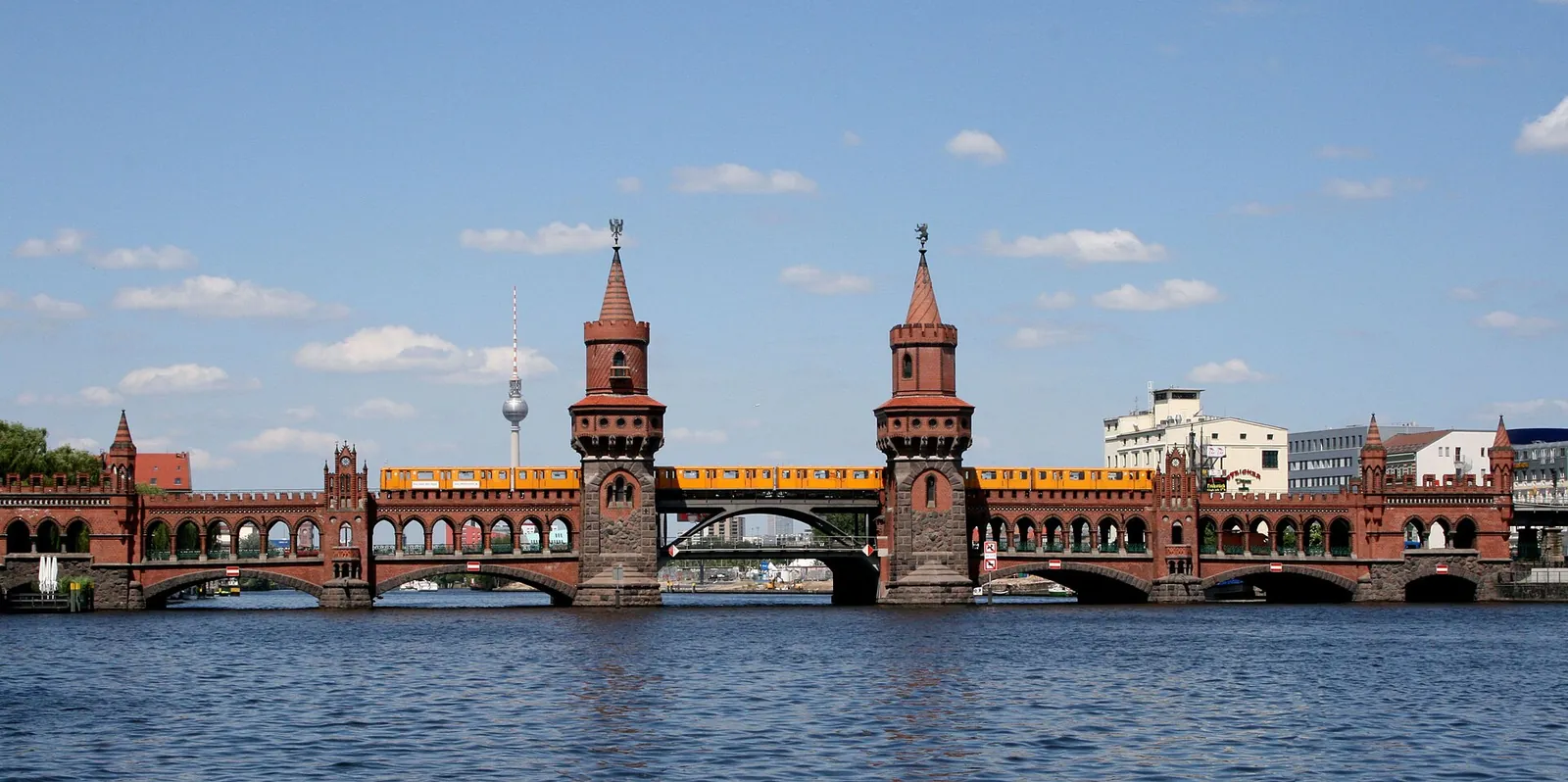 Yellow U-Bahn train crossing the Oberbaum Bridge