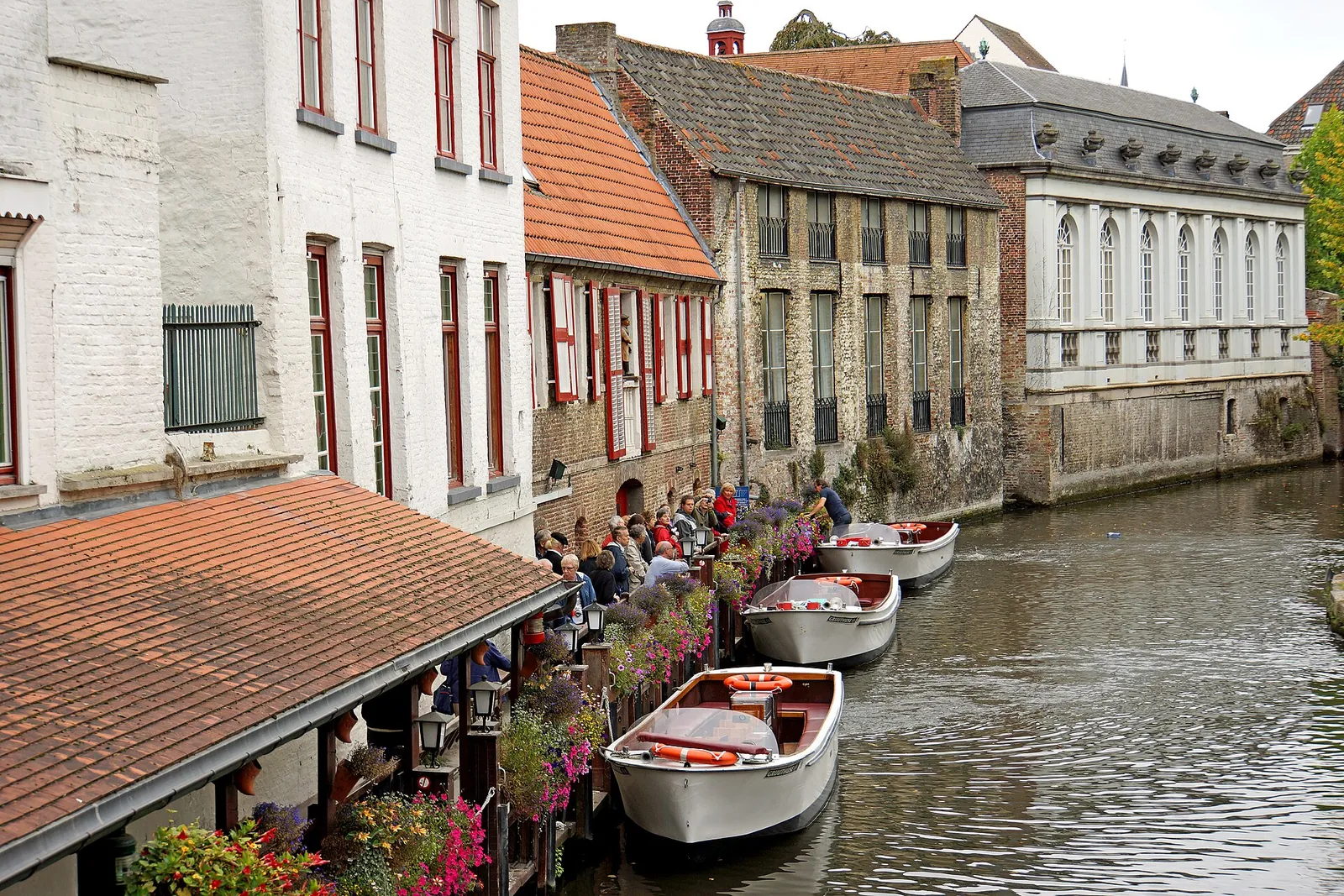 Canal boats moored along a quiet Bruges canal