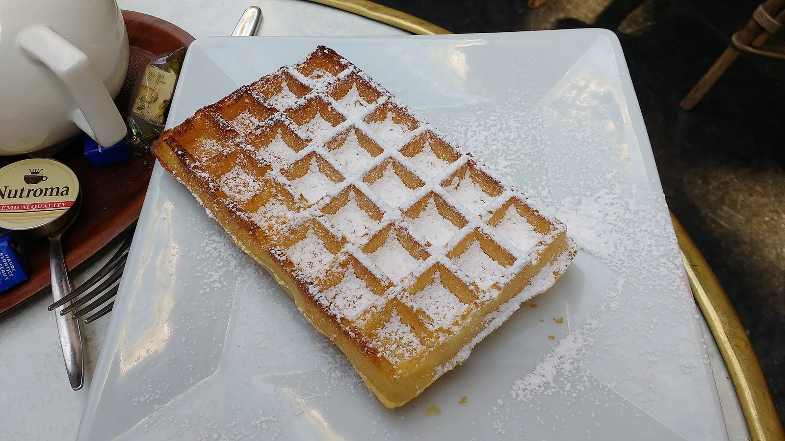 A Brussels waffle dusted with powdered sugar