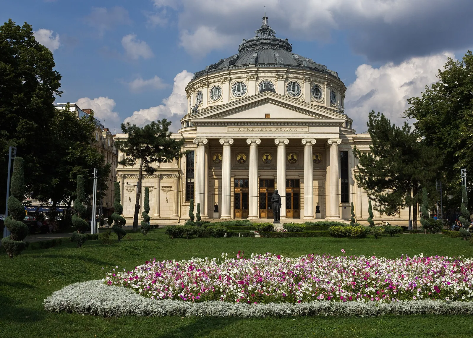 Romanian Athenaeum with flowerbeds on a sunny day