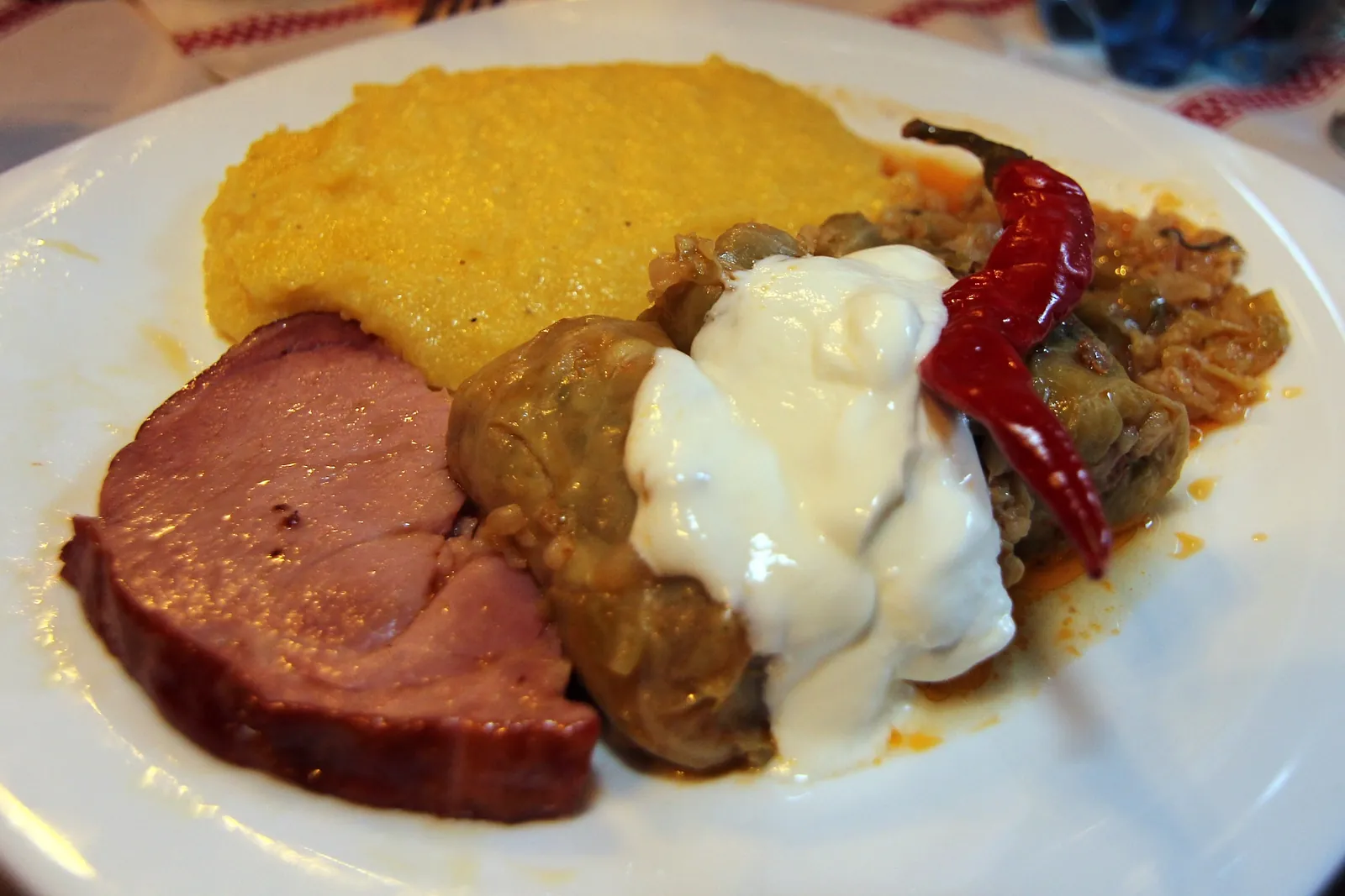 Sarmale with polenta, sour cream and chilli