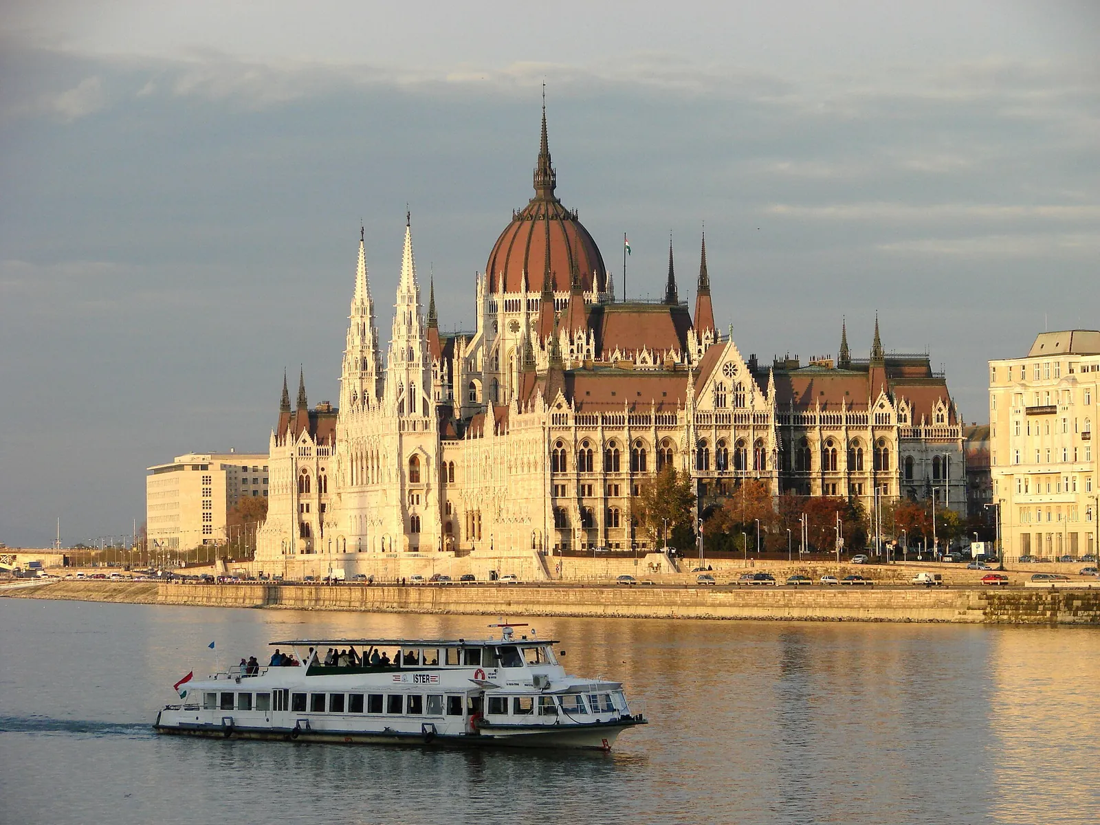 Parliament and a cruise boat on the Danube in golden light