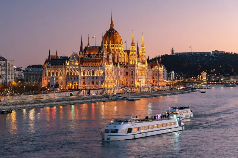 Hungarian Parliament glowing on the Danube at dusk