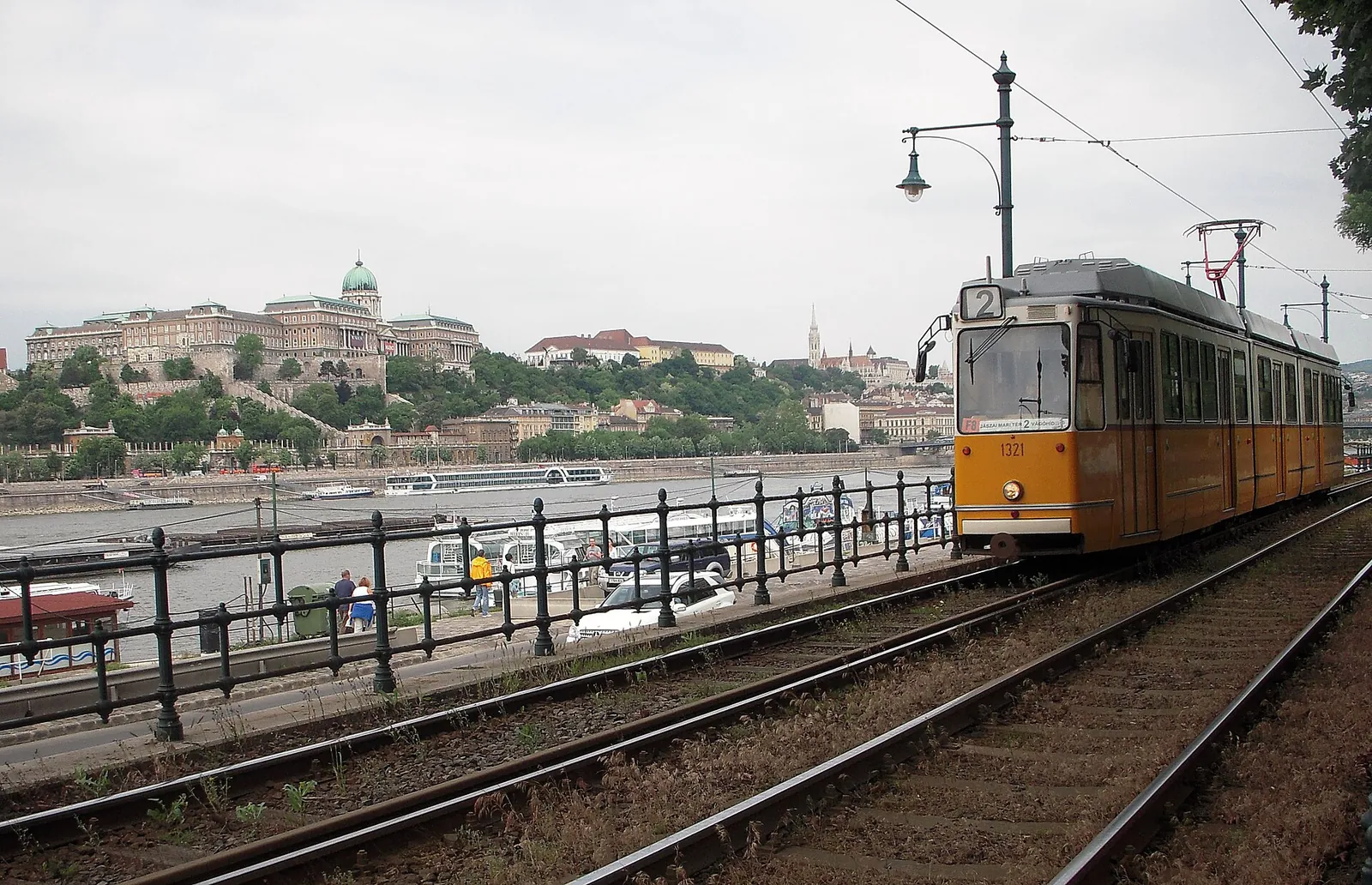 Yellow tram on the Danube embankment below Buda Castle