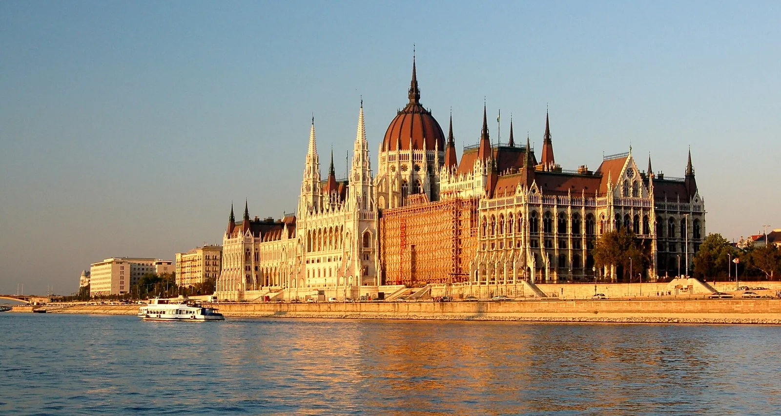 The Parliament glowing gold across the Danube