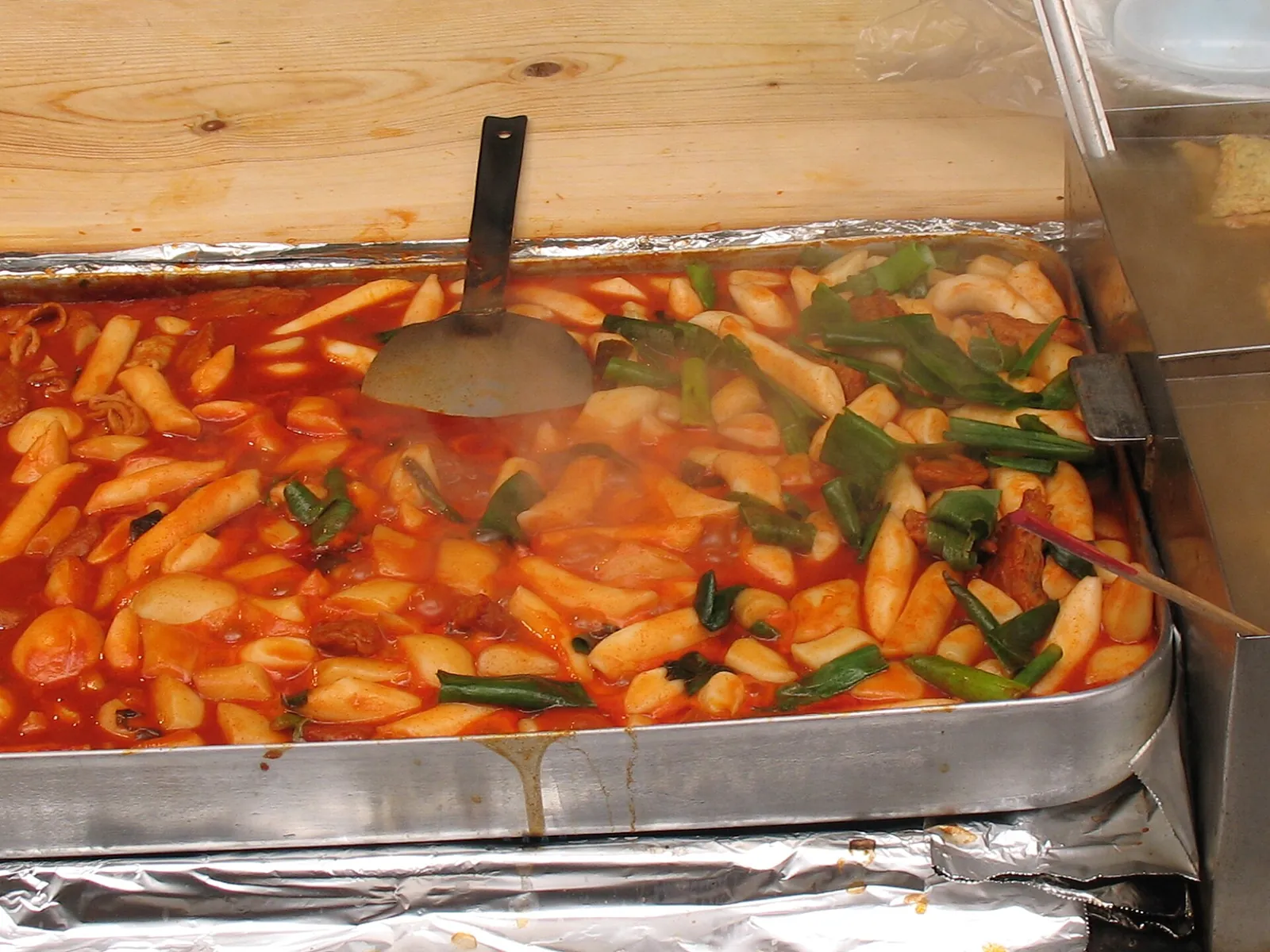 A tray of spicy tteokbokki at a street food stall