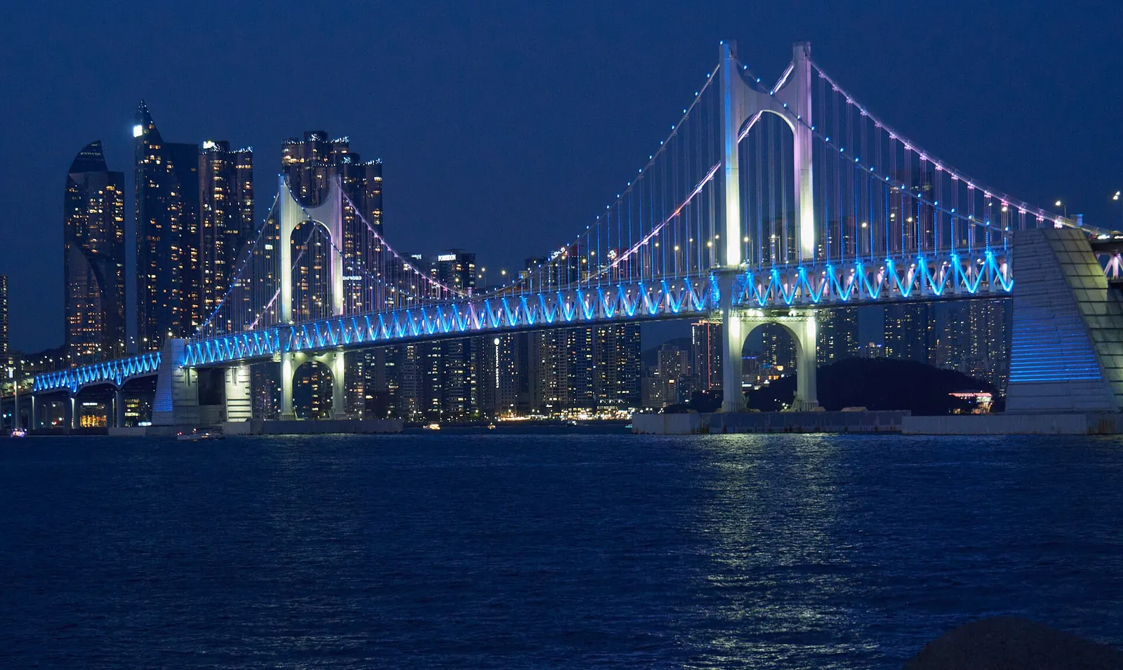 Gwangan Bridge lit up blue over Gwangalli Beach