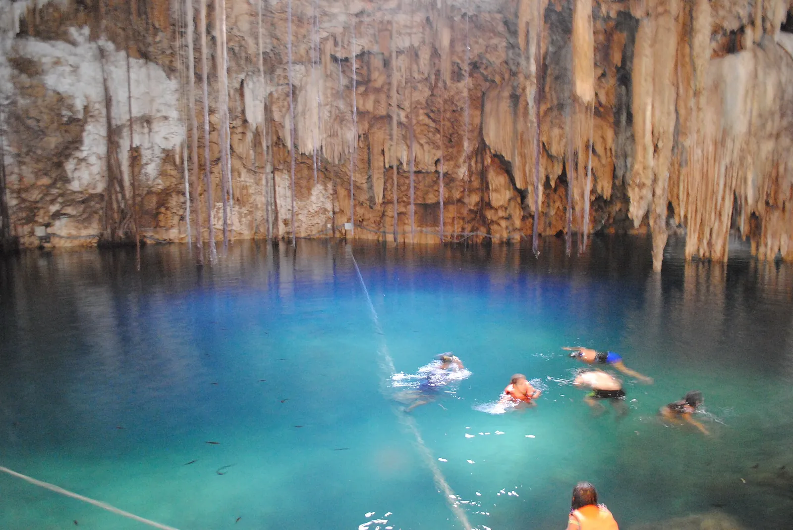 Swimmers in the blue water of Cenote X'Kekén
