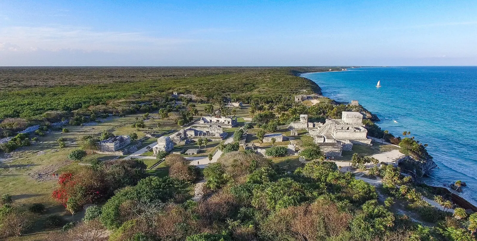 Tulum's walled Maya city on the cliffs from above
