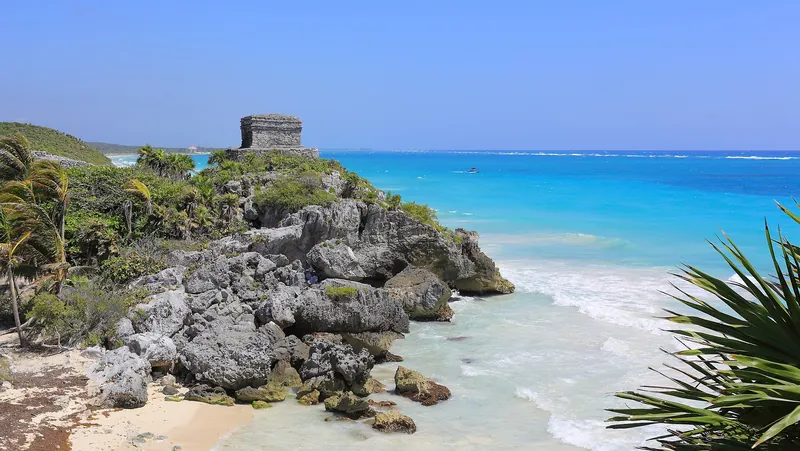 Tulum's clifftop temple above a turquoise Caribbean cove