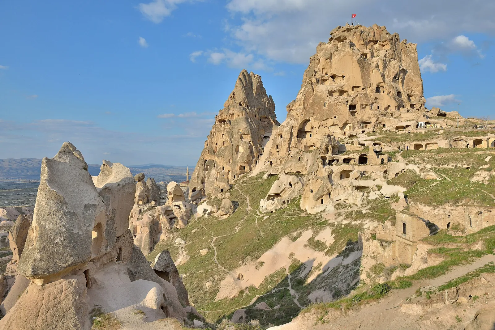 Uchisar Castle and cave dwellings under blue sky
