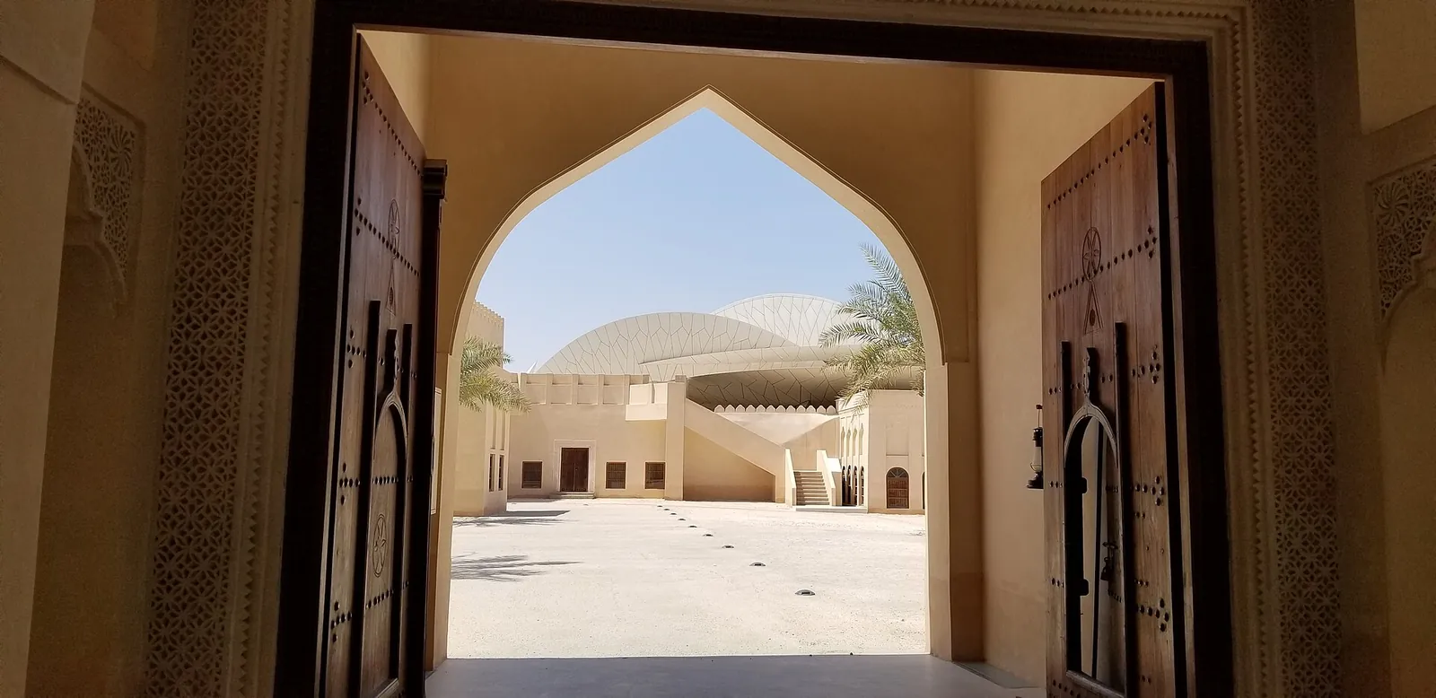The National Museum of Qatar framed by a carved doorway