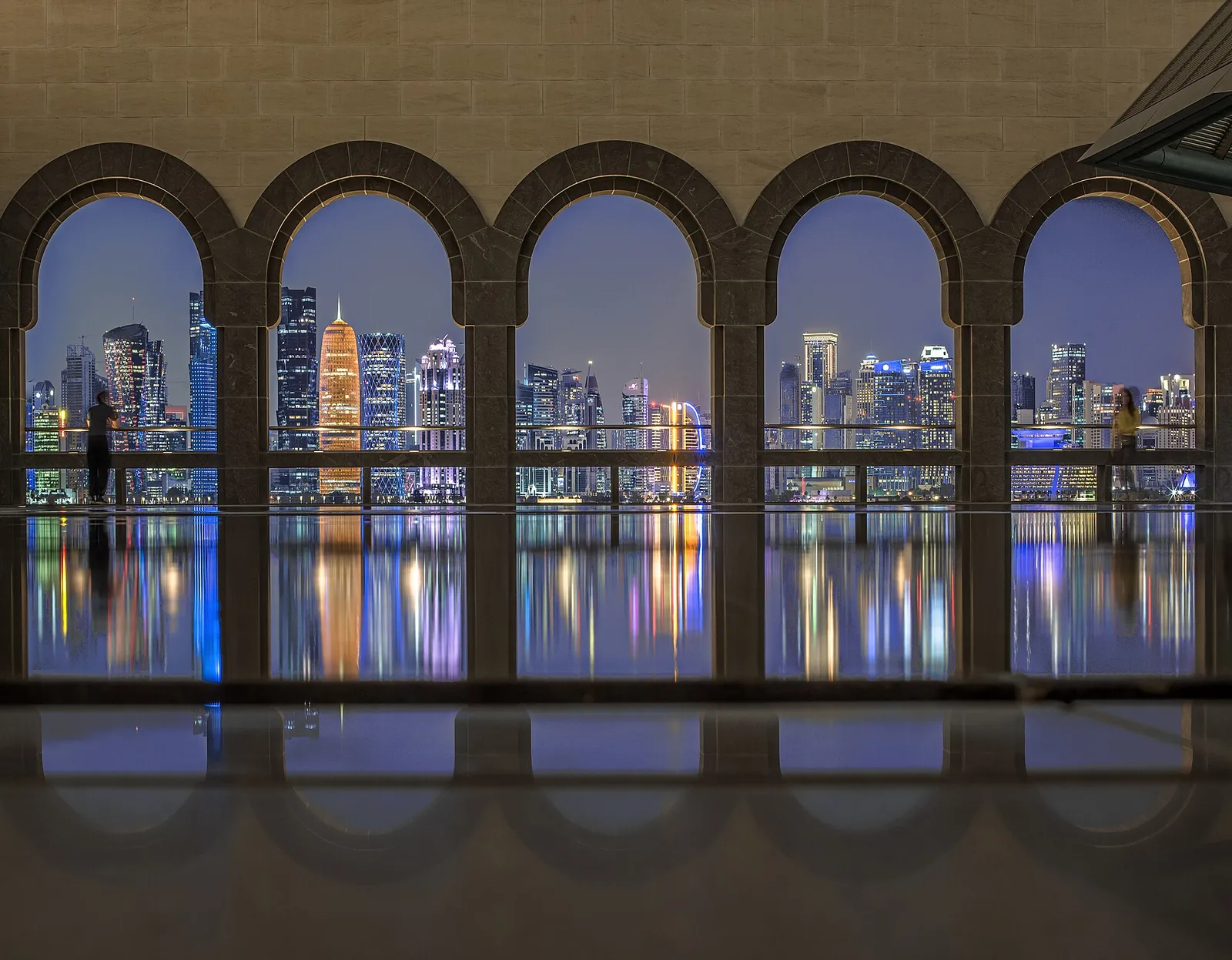 West Bay towers glowing through the MIA arches
