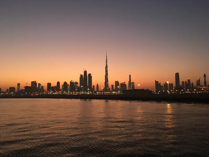 Dubai skyline and Burj Khalifa glowing at sunset