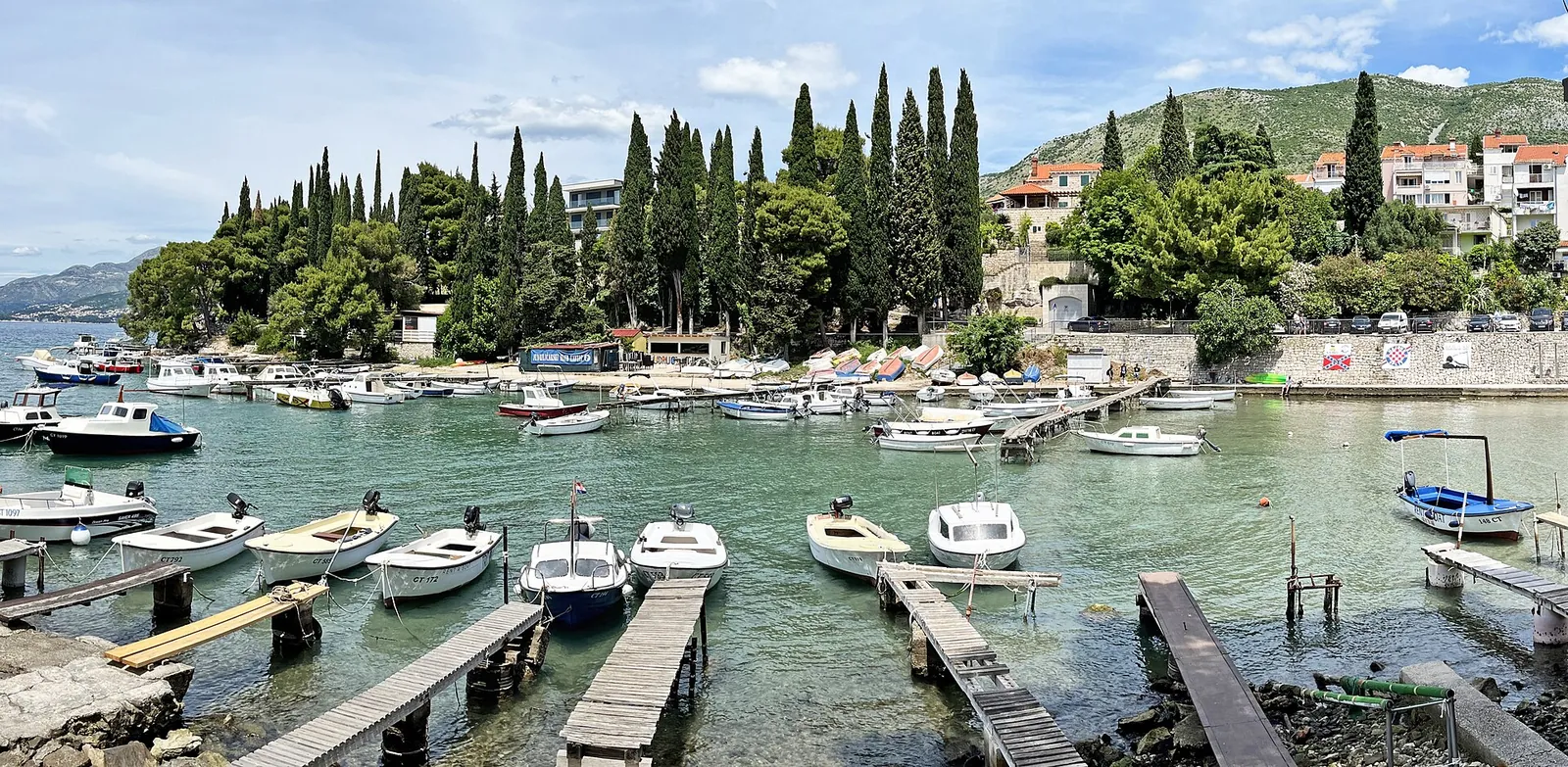 Boats and cypress trees in Cavtat harbour