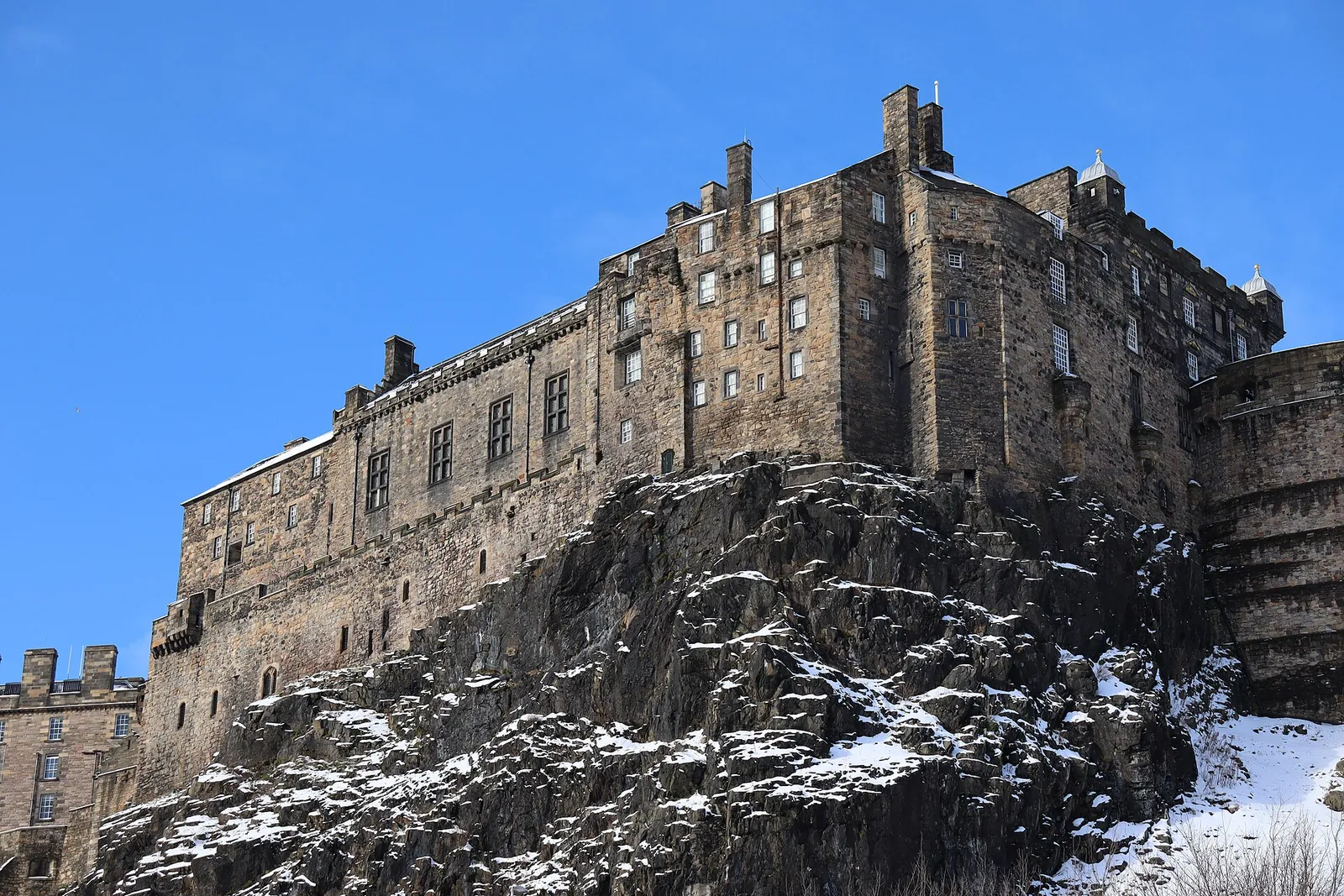 Edinburgh Castle perched on its rock under blue sky