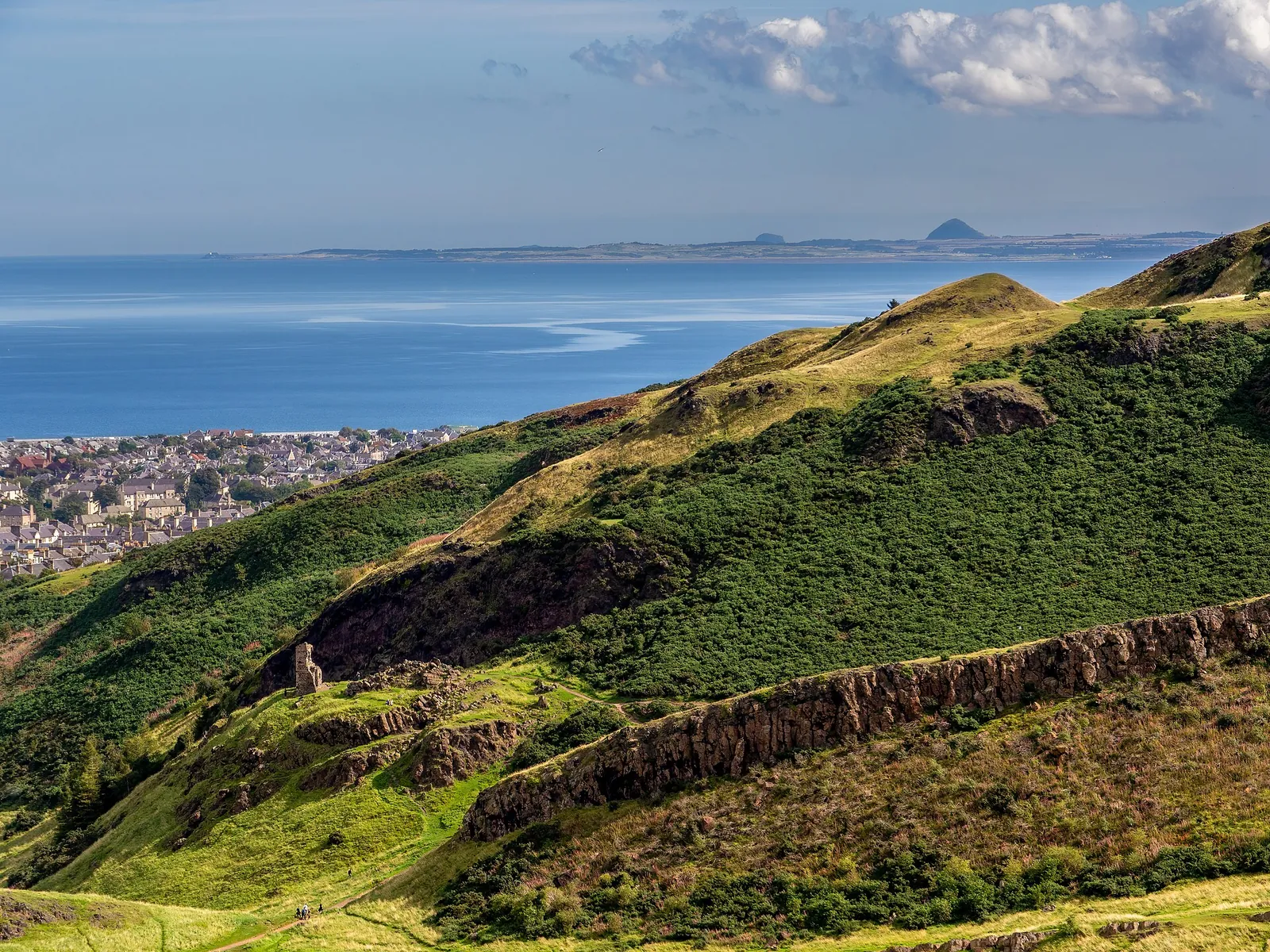 Green slopes of Arthur's Seat above the sea