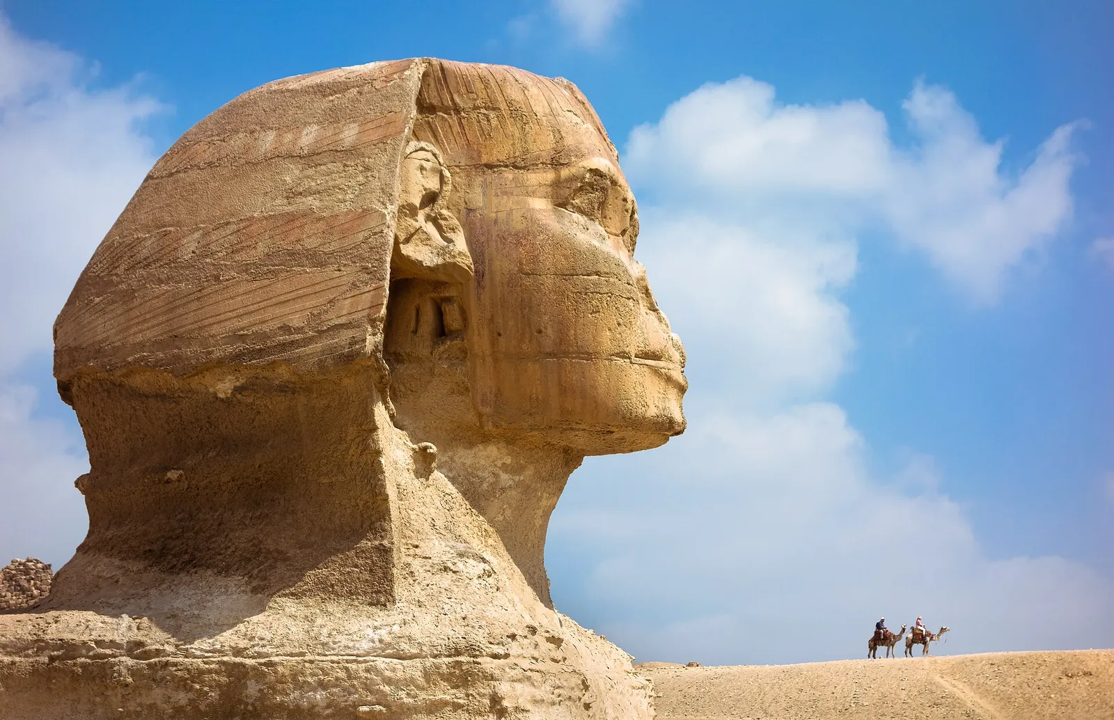 The Great Sphinx of Giza against fluffy white clouds