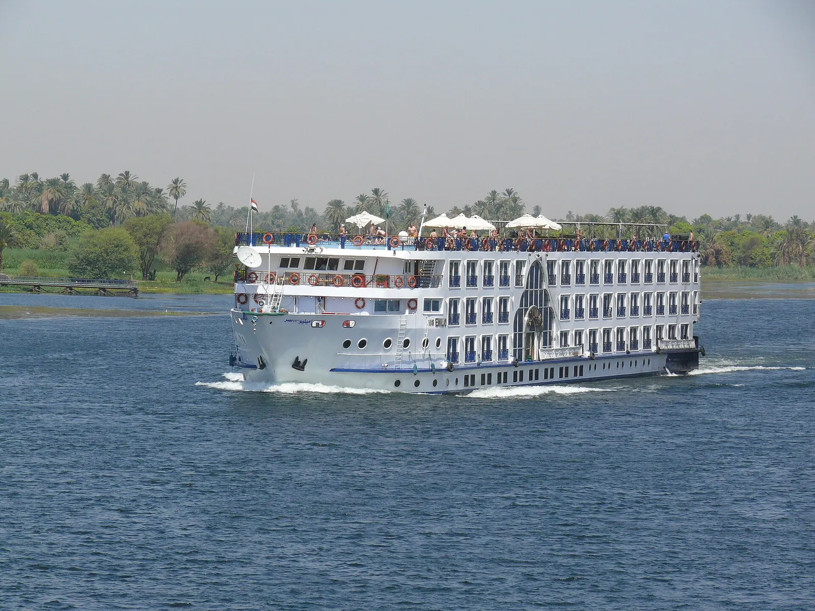 A Nile cruise boat gliding past green riverbanks