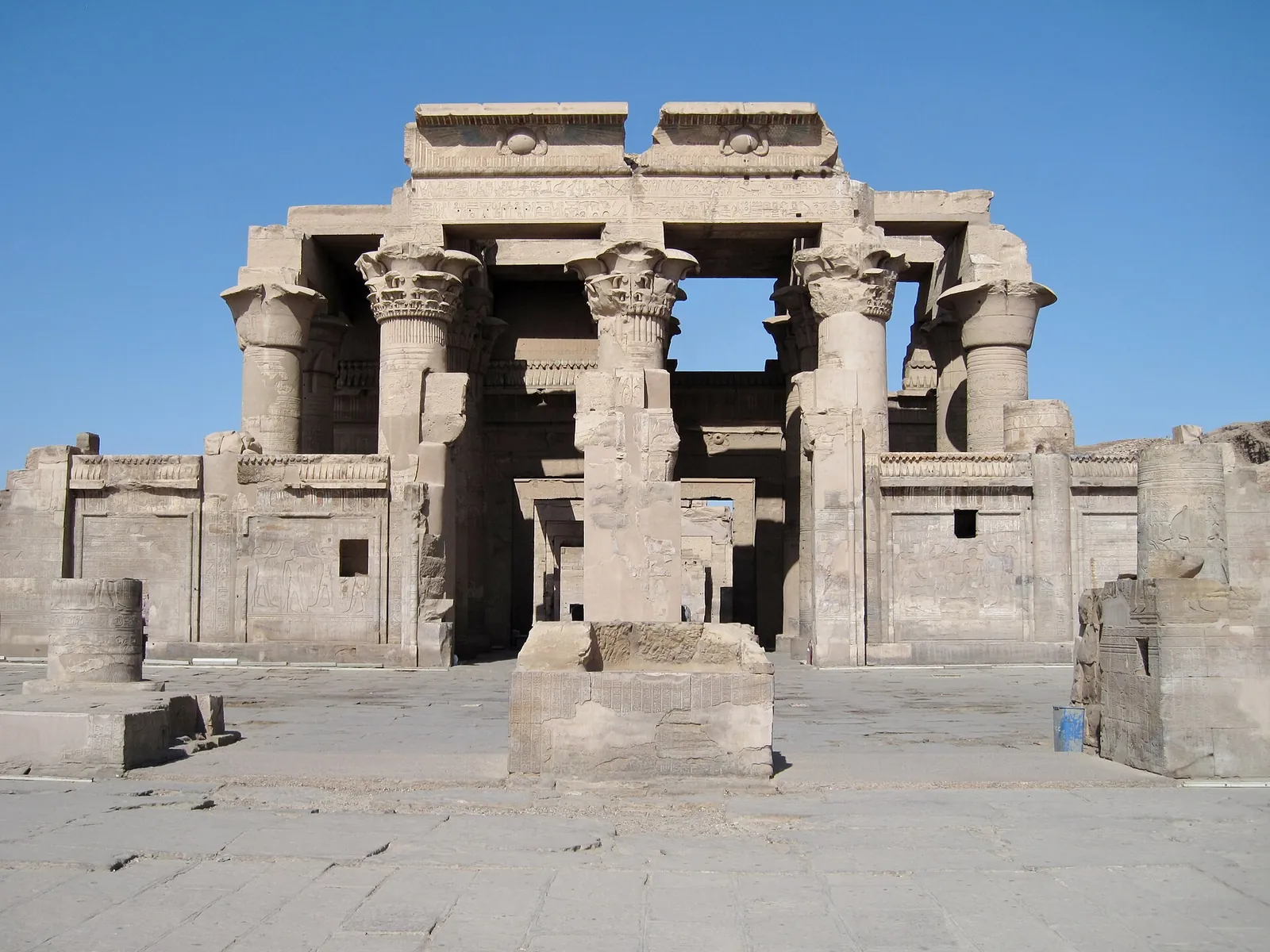 Columns of Kom Ombo Temple under a blue sky