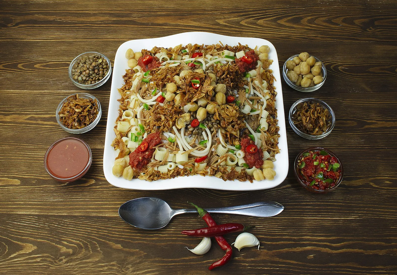 A big dish of koshary with spices on the side