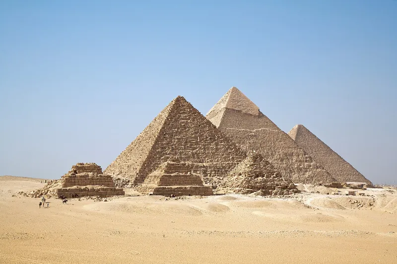 The three Pyramids of Giza under a clear blue sky