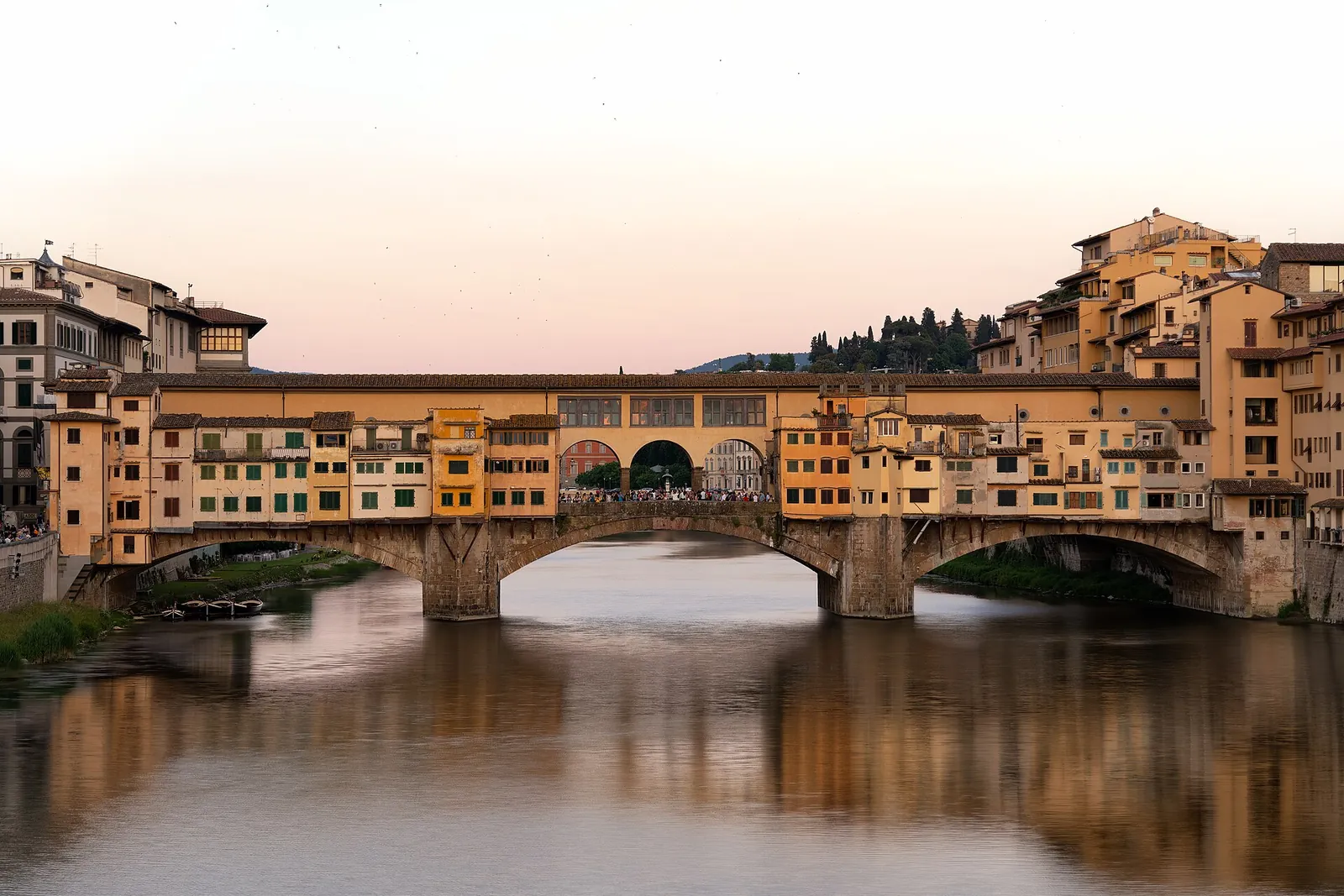 Ponte Vecchio reflected in the Arno at dusk
