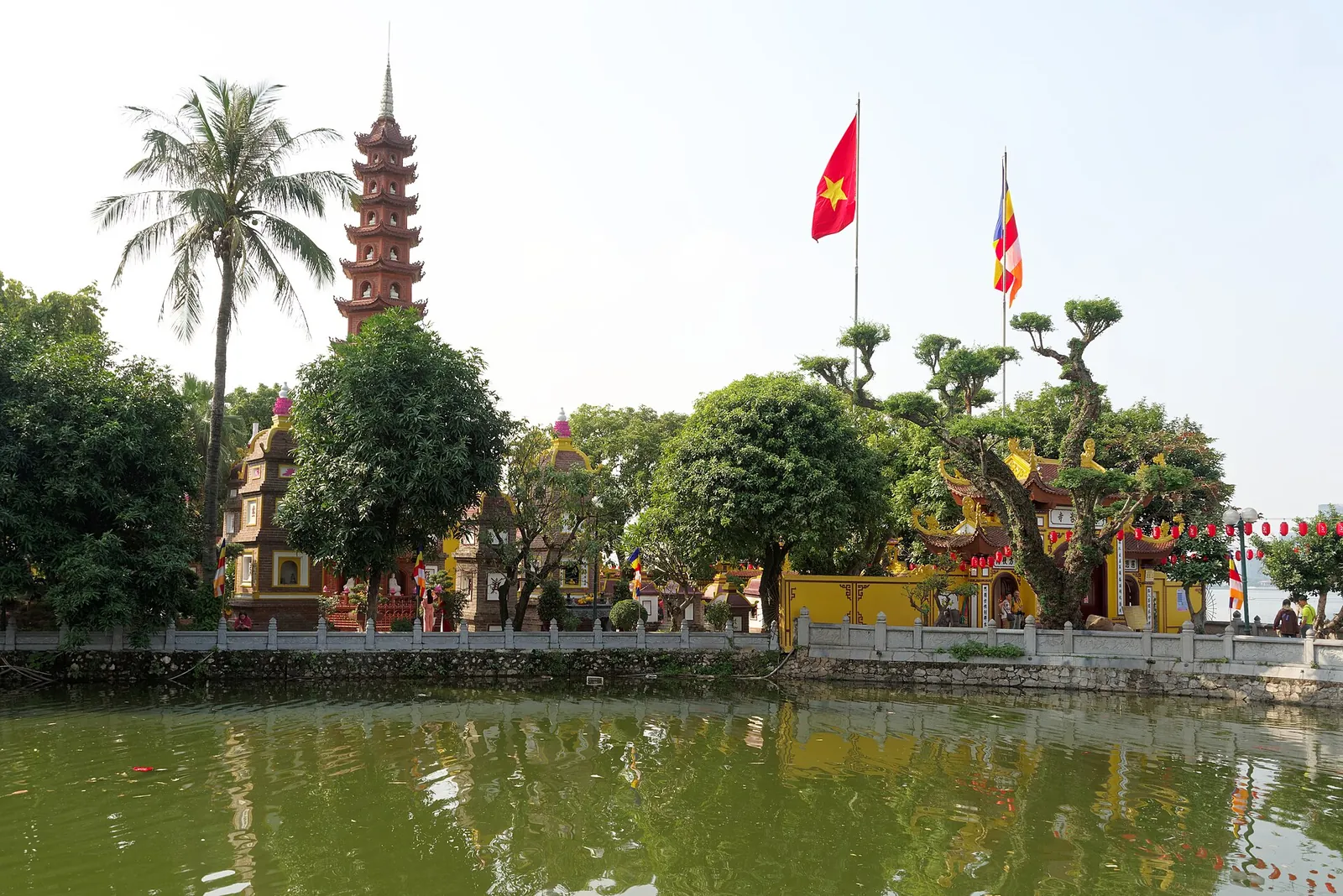 Tran Quoc Pagoda's red tower rising beside West Lake