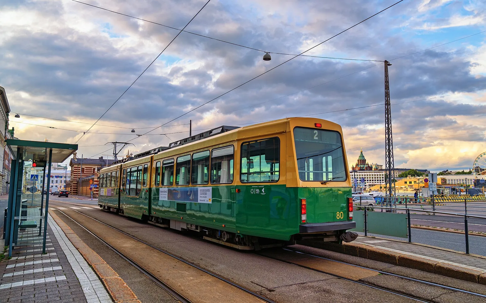 Green and yellow HSL tram on a summer evening