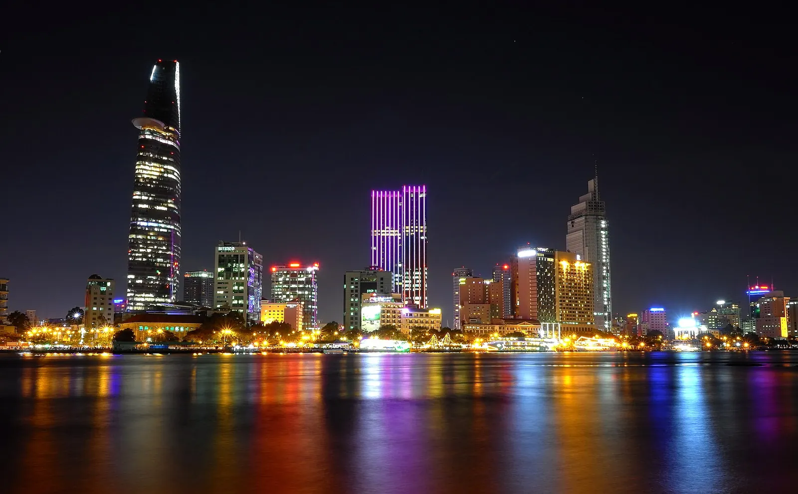 Saigon's towers lighting up the river at night